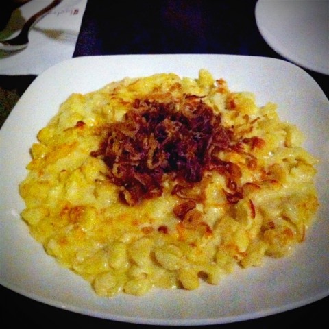 Homemade Bavarian spatzle with assorted melted cheese and fried onion