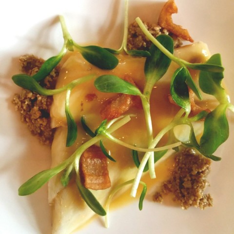 poached seabass with lotus roots and sunflower seeds praline topped with locally sourced sprouts